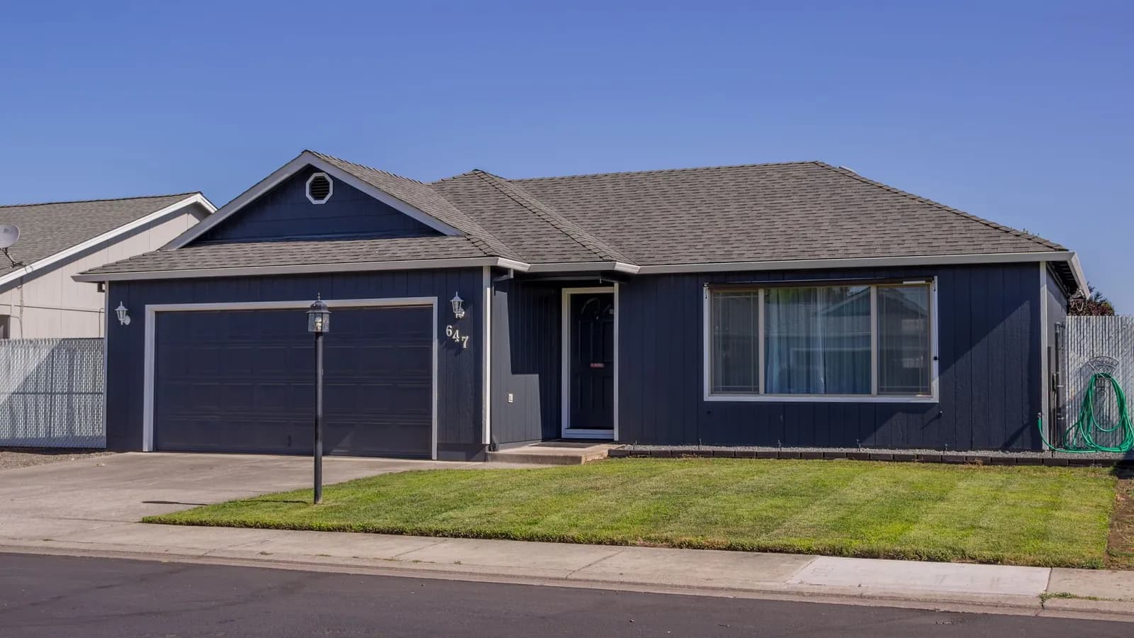 Single-story California ranch-style home with a long, low-pitched roof and attached garage