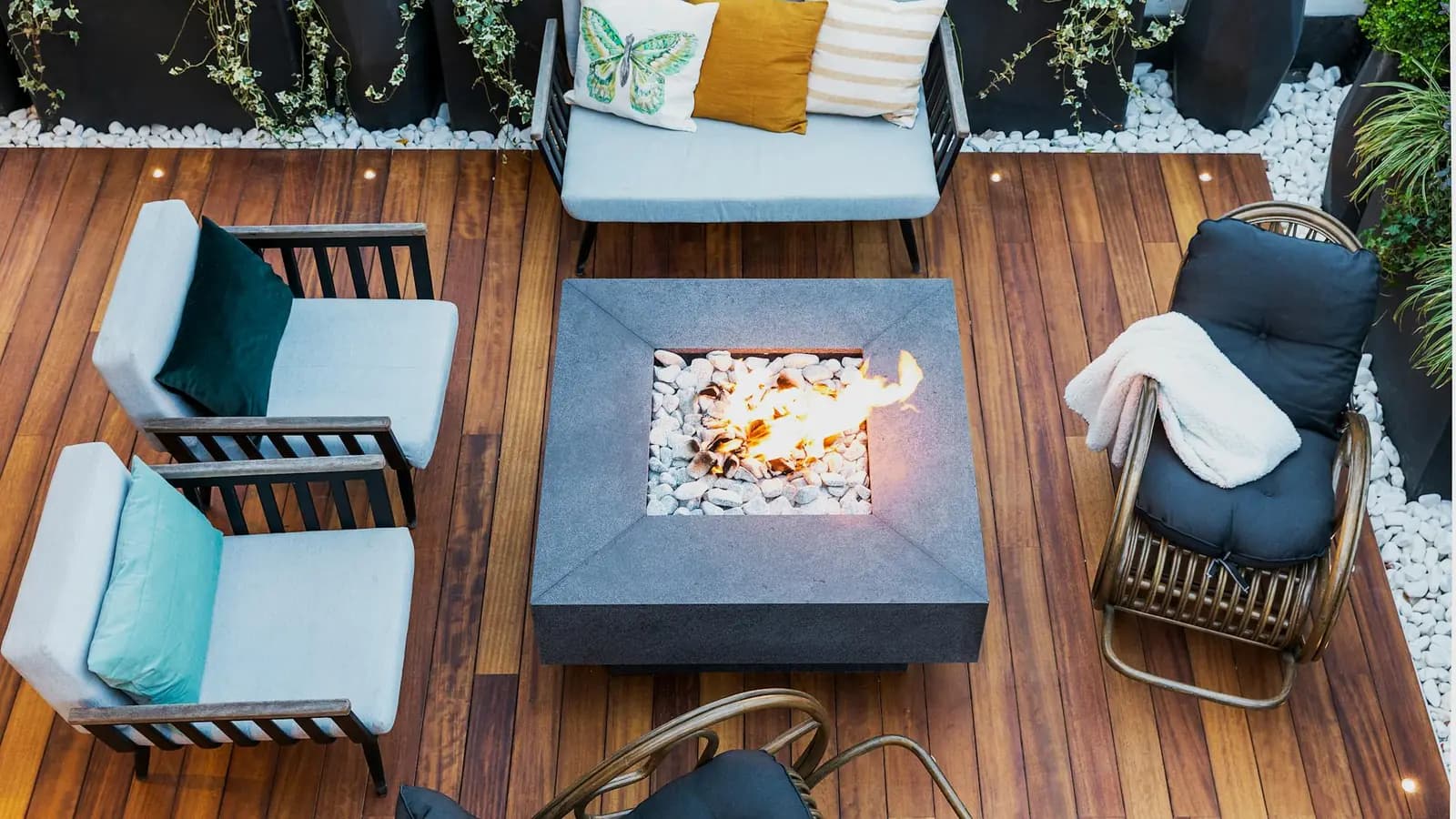 Aerial view of a large composite outdoor-living deck with a central fire pit and lounge seating
