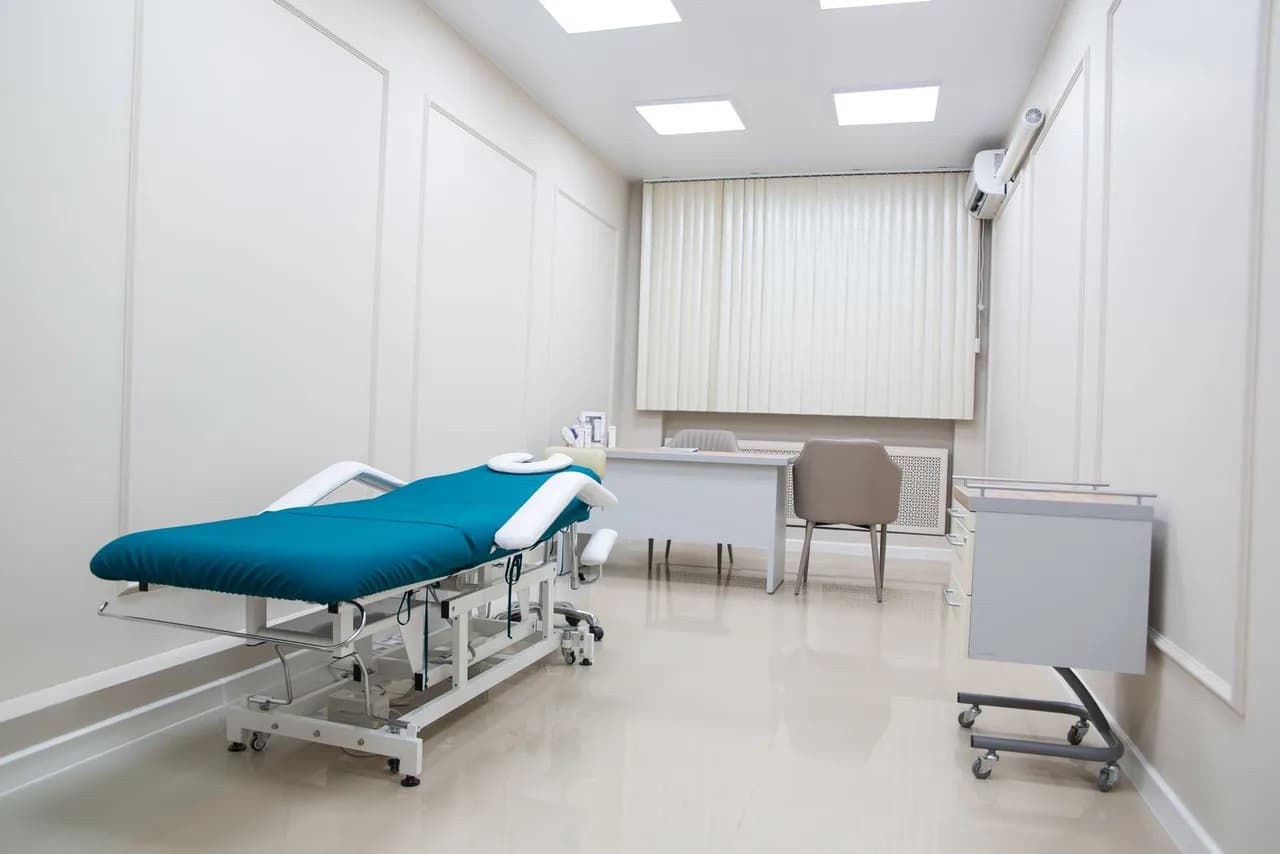 Finished medical office exam room with an examination table and clean modern casework