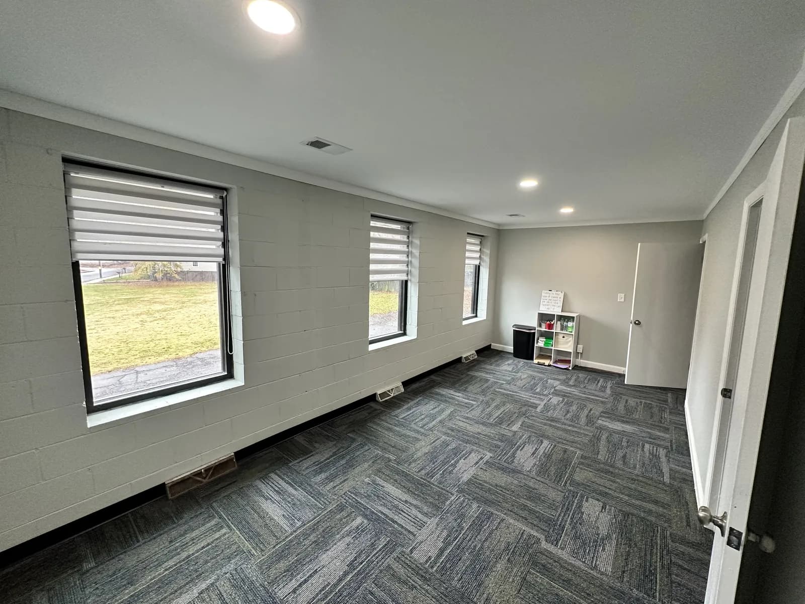Remodeled open-concept living room with herringbone flooring